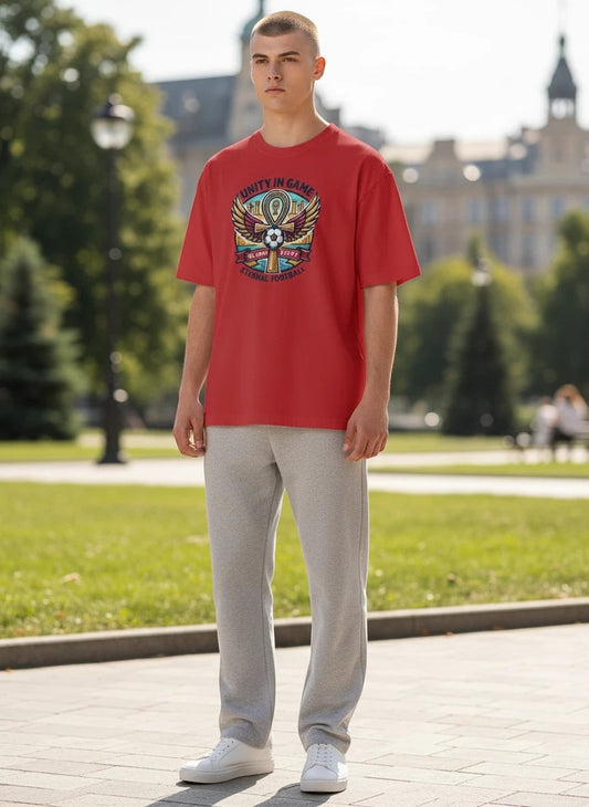 Coptic Mary Shop red cotton t-shirt with Egypt 2026 World Cup graphic featuring an ankh, wings, and football.