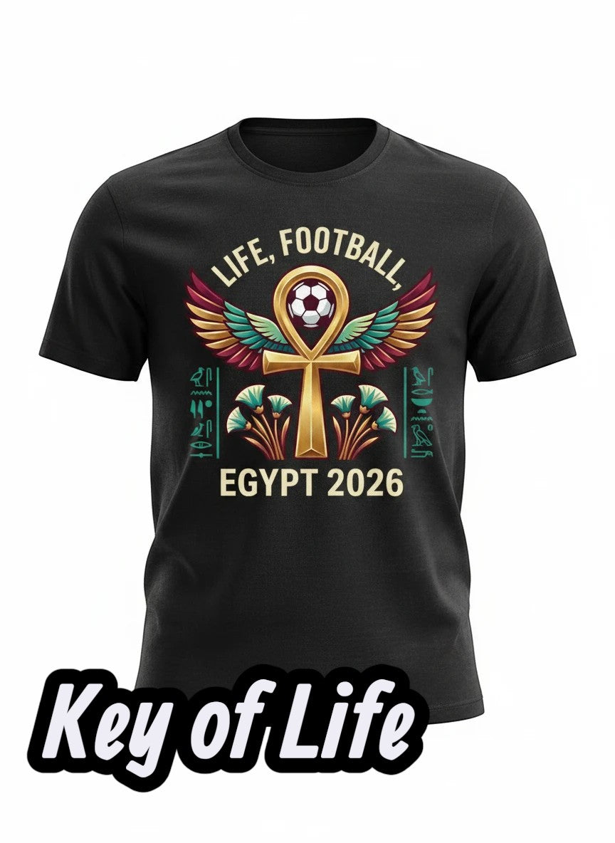 Coptic Mary Shop black cotton t-shirt with Egypt 2026 World Cup football graphic featuring an ankh symbol, wings, hieroglyphs, and lotus flowers.