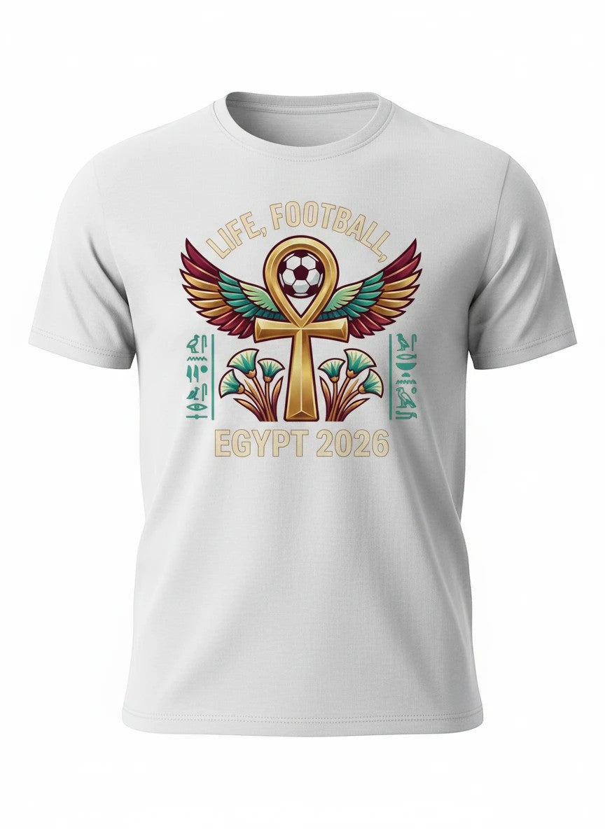 Coptic Mary Shop white cotton t-shirt with Egypt 2026 World Cup graphic featuring an Ankh, wings, football, hieroglyphs, and lotus flowers.