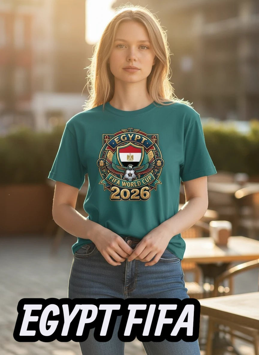 Coptic Mary Shop teal cotton t-shirt with Egypt FIFA World Cup 2026 graphic print. Model is wearing jeans.