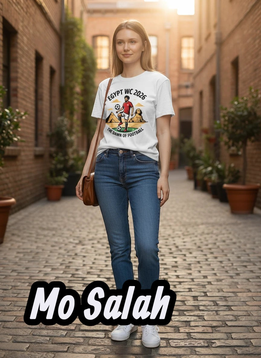 White cotton t-shirt with graphic print of a soccer player, pyramids, and Sphinx, text "EGYPT WC 2026 THE DAWN OF FOOTBALL".